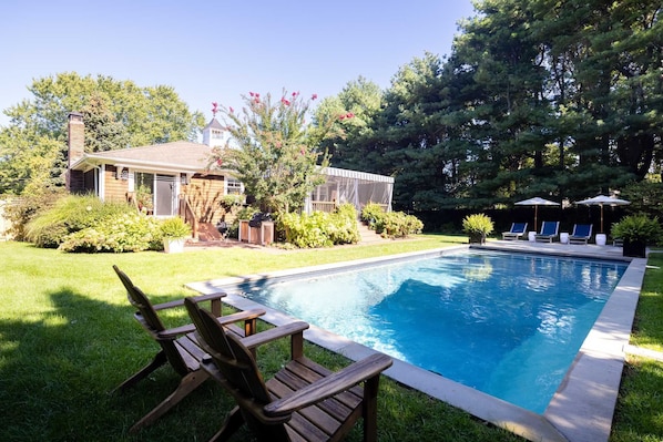 A pristine pool complemented by inviting lounge chairs.