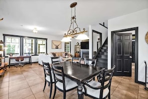 Dining room, stairway to loft, living room and desk area