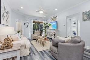 Comfortable living area with huge smart TV and access to the patio and pool area.