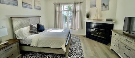 Master bedroom with queen size bed and smart TV