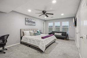 Master Bedroom (floor 1) with King size bed, couch, workstation and 55” Roku TV.