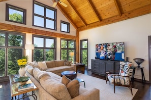 Living room with Vaulted Ceiling and Windows