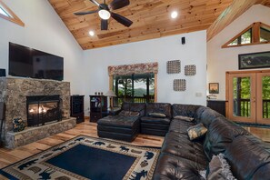 Living Room has a gas log fireplace, TV large section sofa.