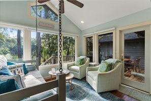Sunroom is adjacent to lagoon-front deck/eating area.