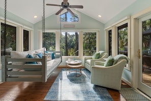 Sunroom is a popular destination with Swing bed, swivel chairs & wall mounted TV