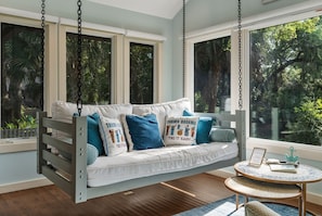 Guests rave about vaulted sunroom with Swing Bed overlooking lagoon.