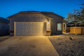 Well-lit entry way. 2 car garage and additional parking in driveway.