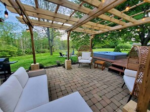 Updated bohemian patio furniture to enjoy under the newly built pergola while grilling your dinner on the provided propane grill