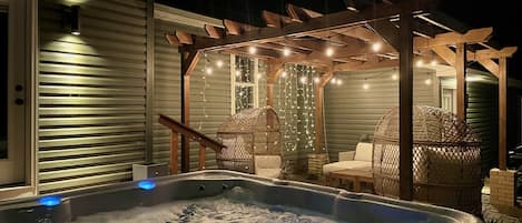 Soak in the hot tub with the dazzling lights on the porch 