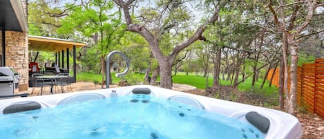 Unwind and relax in the private hot tub at Red Bird Cottage