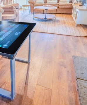 A digital gaming table with a Scrabble game on display, blending modern entertainment with the traditional comfort.