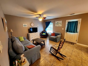 Spacious living area with a large smart TV...