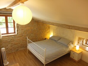 Overview of the stone built bedroom, with a great bed