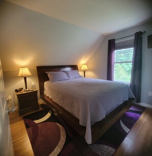 bedroom with queen and smart tv