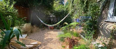 Tropical garden, hammock, and multiple seating options. 