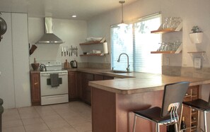 Roomy bright kitchen with concrete counter tops