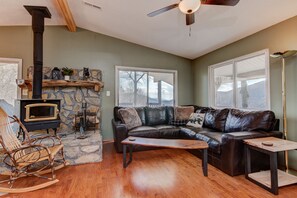 Main living area with wood burning stove and mountain views