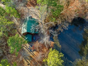 Aerial view of cabin and pond