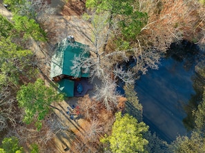 Aerial view of cabin and pond