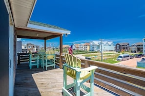 Partially covered deck off the dining/living areas looks up to endless stars