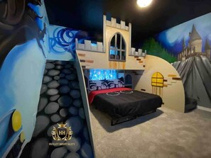 Bedroom 6: Harry Potter Pavilion featuring a custom Hogswart castle bunk bed with twin bed over full size bed with staircase and slide. Join us in this exquisite themed room with smart TV 