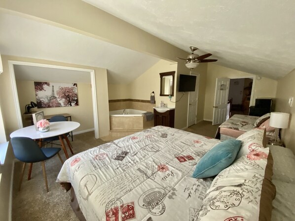 Work area, jacuzzi tub, king bed, twin bed, bathroom, vanities, tub / shower.