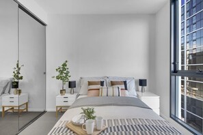 A 2nd bedroom with a queen sized bed and plush pillows.