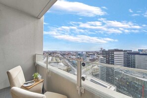 A balcony with city views. (chairs on balcony are from the dining area)
