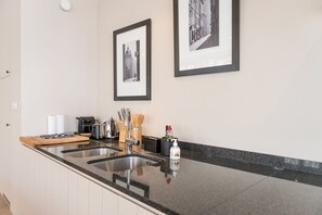 Kitchen space with granite counterops and all the amenities and high-quality tools needed to bring your culinary pursuits to life.