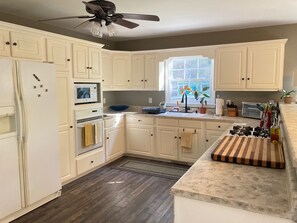 Fully-stocked spacious kitchen. Gas stove top.