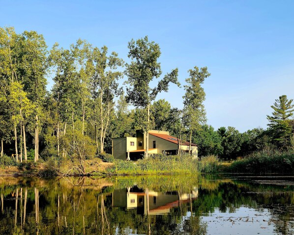 Nestled on a private community lake with 225'  of lakefront on 4 wooded acres