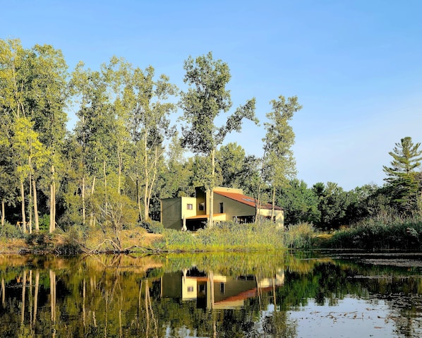 Nestled on a private community lake with 225'  of lakefront on 4 wooded acres