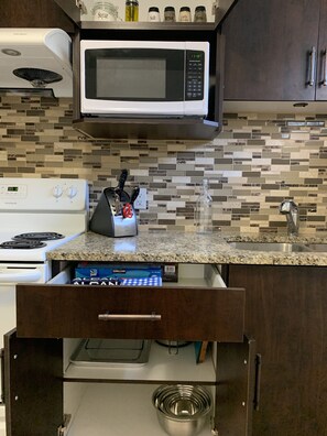 Kitchen 3, Knife block, Microwave, essential spices, mixing bowls. 