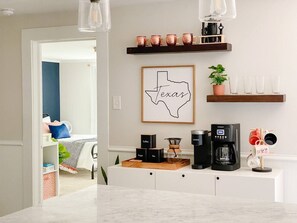 The coffee & happy hour bar is ready to rock your mornings and evenings. Here you'll find a drip coffee maker, along with keurig and pour over.