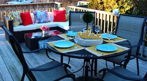 Large deck with lounge area and outdoor dining.
