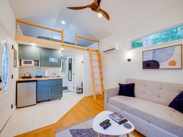 Creekside Cottage is a tiny home that's big on features. Lofted queen bed.