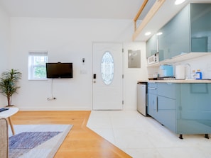 TV, kitchenette with Keurig coffee, and smart lock entry system.
