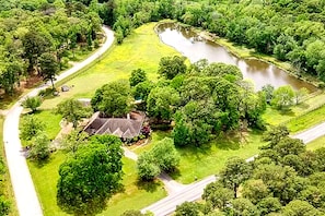 The house sits on 10-acres and includes a private 2-acre lake (w/ great fishing)