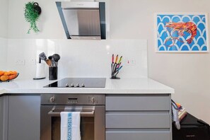 Kitchen: Whip up culinary delights in this sleek kitchen featuring modern appliances and vibrant decor!