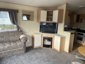 Living room with gas fire and 42” tv with sound bar