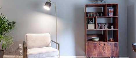 Reading chair with elegant lighting and display bookcase. 