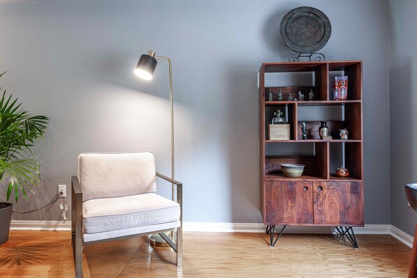 Reading chair with elegant lighting and display bookcase. 