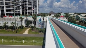 sky walk from tiki bar on beach to pool area at resort