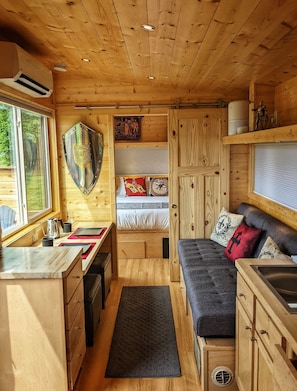 Main living area and private bedroom with queen bed