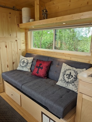 Lots of natural light and a sofa provides a nice place to relax