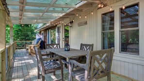 Deck partially covered featuring dining, lounging and grill