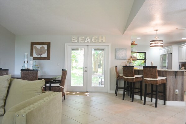 Doors lead to the private back yard where you can hear waves from the beach