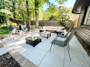 Patio seating with wood burning fire pit and gas grill 