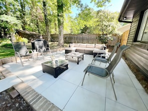 Patio seating with wood burning fire pit and gas grill 