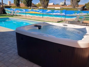 Hot tub overlooking Pool, bocce ball and island landscape wall